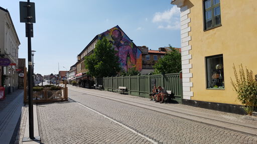 Painted man facing the house